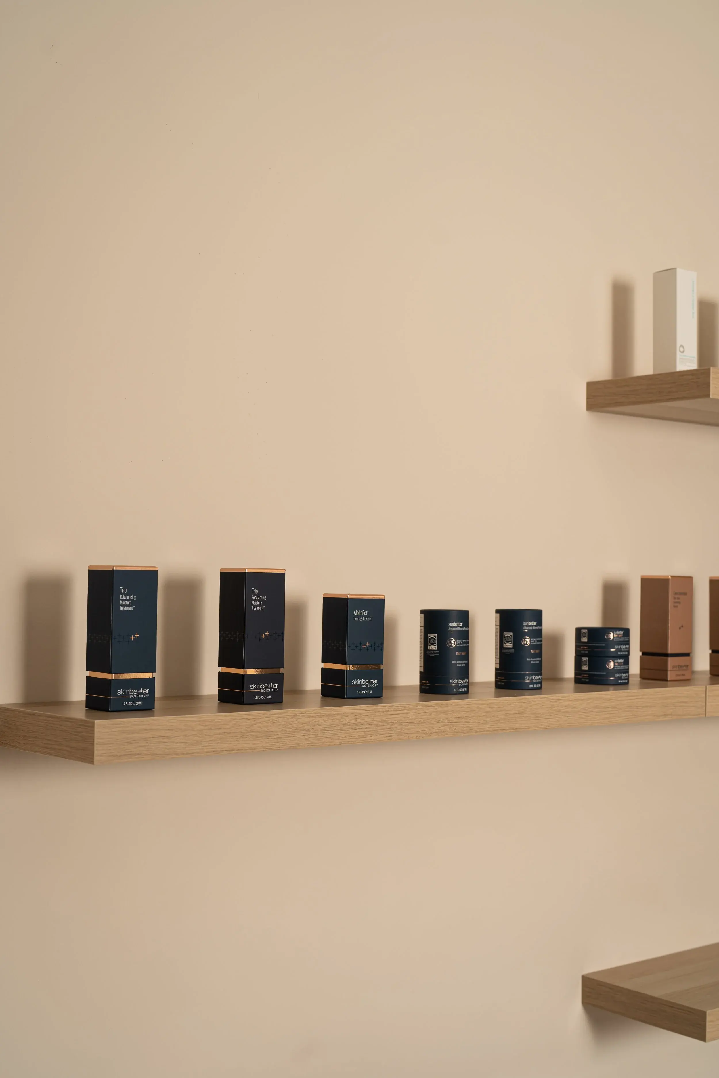 skinbetter science boxes arranged on a wood shelf