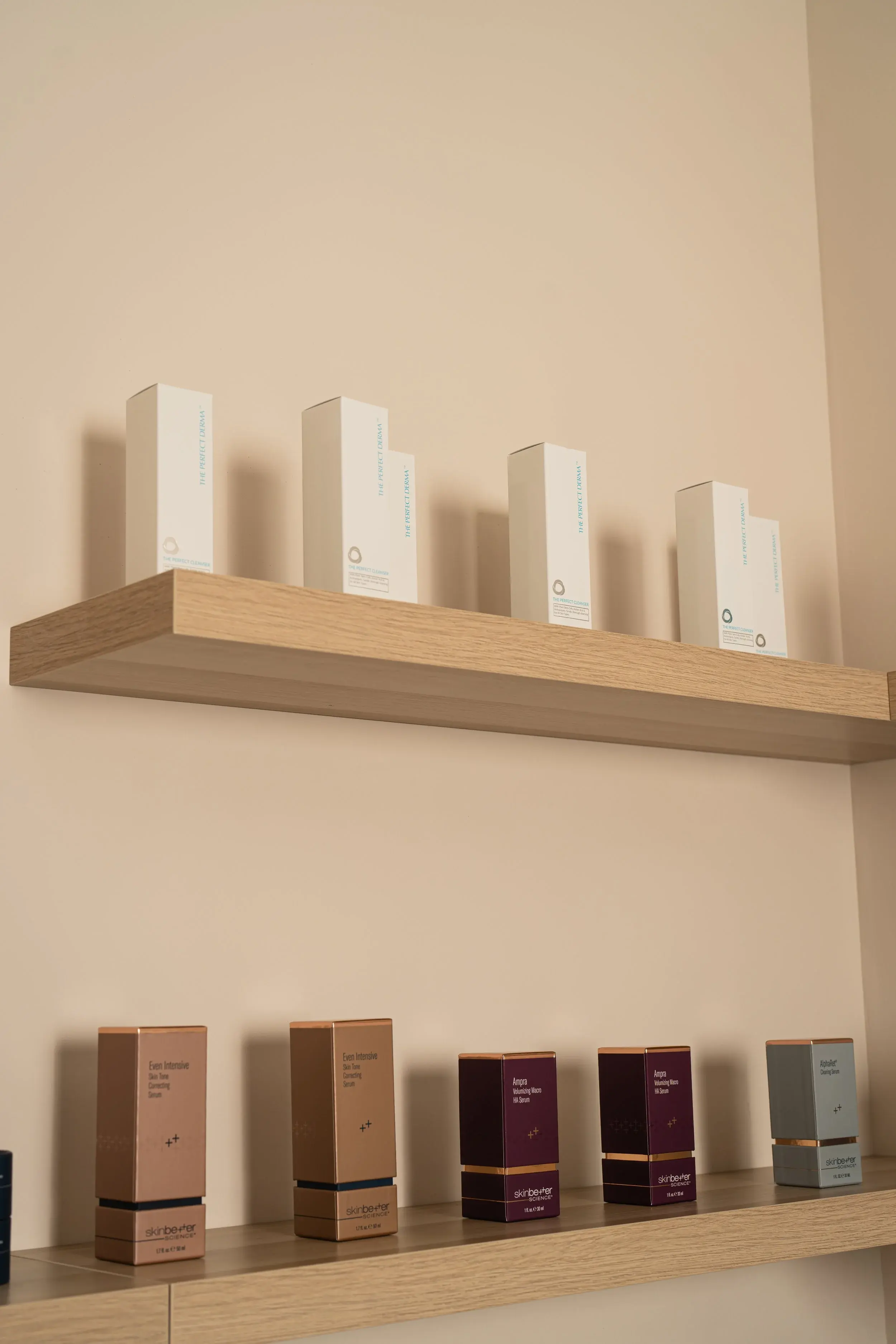The Perfect Derma boxes on an upper shelf with skinbetter science serums below